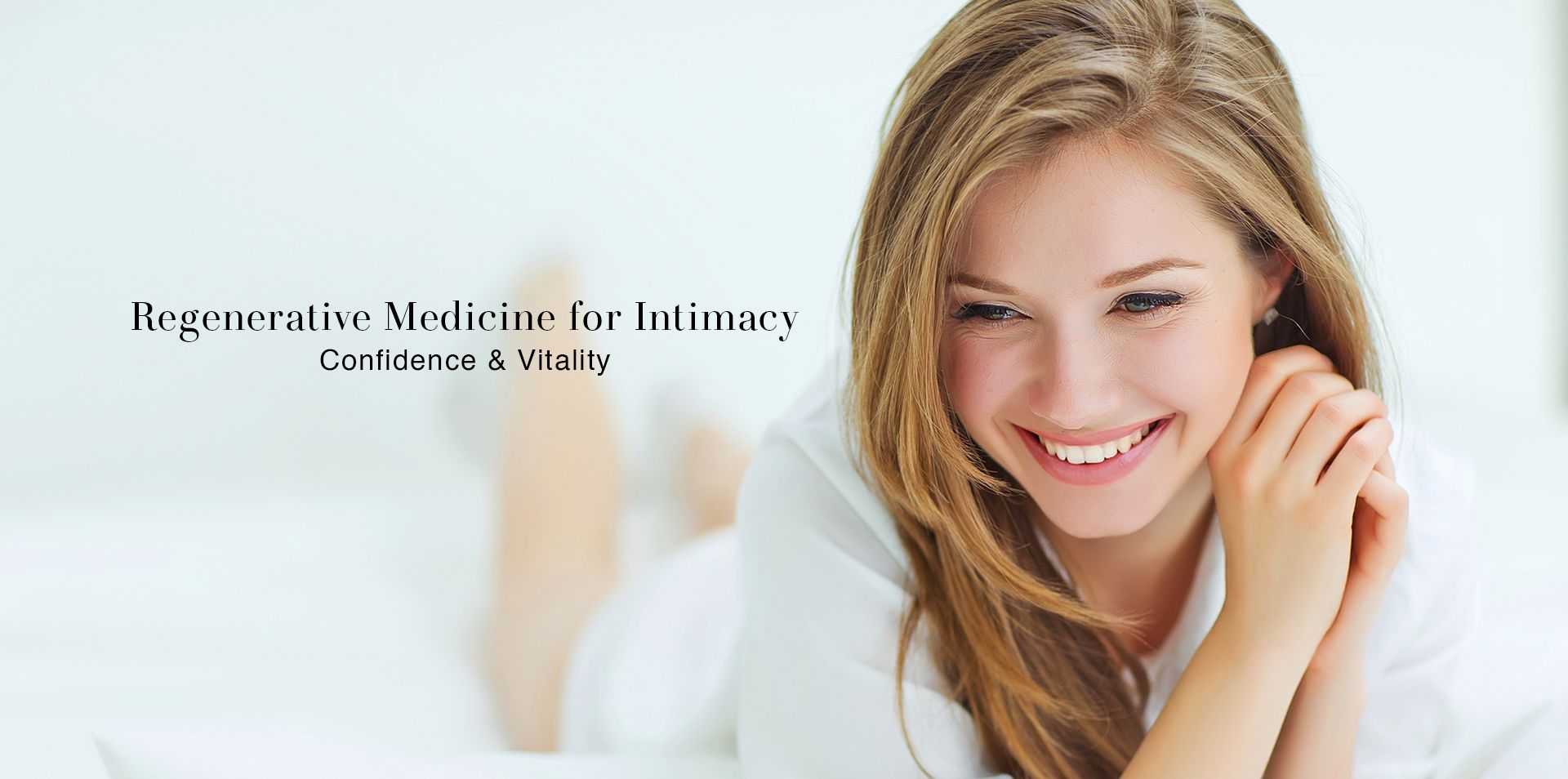 Smiling woman relaxing in white — Regenerative Medicine for Intimacy, Confidence & Vitality