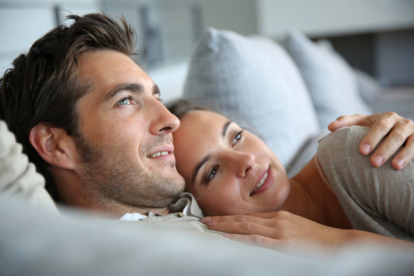 Relaxed couple resting together on a sofa